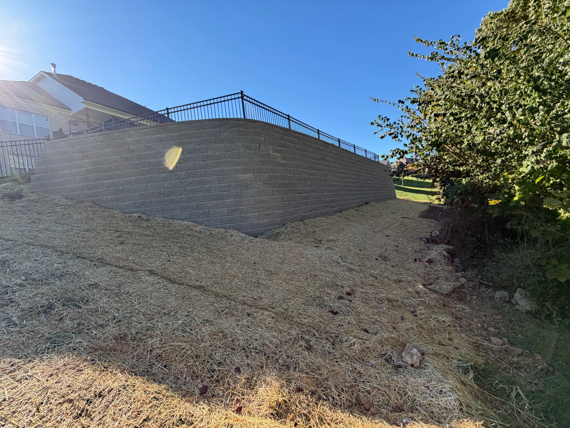Big Block Retaining Wall Turns a Sloped Backyard Into Usable Space image